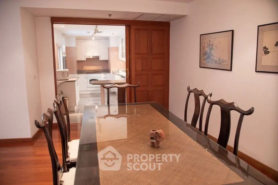 Elegant dining room with wooden furniture and open kitchen layout
