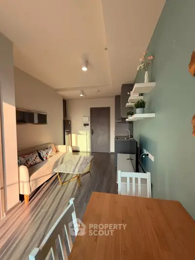 Modern living room with stylish decor and open layout, featuring cozy seating and natural light.