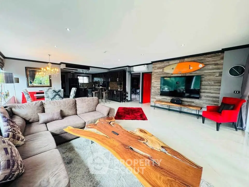 Spacious modern living room with unique wooden table and open kitchen layout