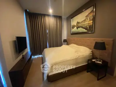 Cozy bedroom with modern decor and large window for natural light