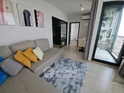 Modern living room with cozy sofa and balcony view in stylish apartment.