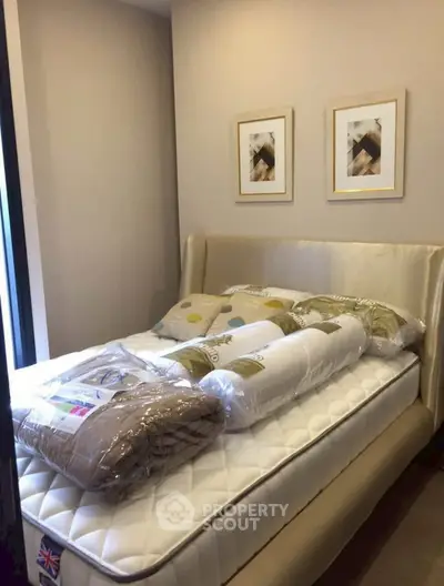 Cozy bedroom with elegant decor and plush bedding in a modern apartment.