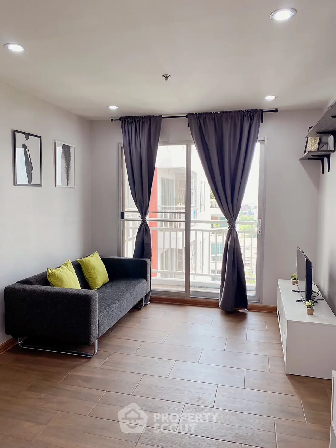 Modern living room with large windows and stylish decor in a contemporary apartment.