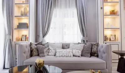 Luxurious living room with elegant sofa and decorative shelves, perfect for modern home buyers.