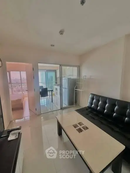 Modern apartment with open layout, featuring a sleek living room and kitchen area, perfect for urban living.