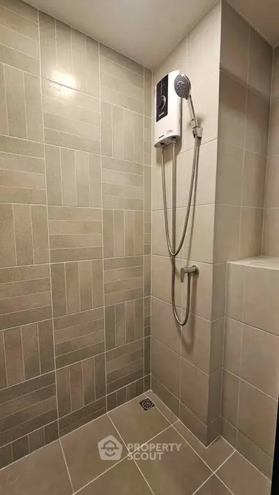 Modern bathroom with sleek shower and neutral tile design