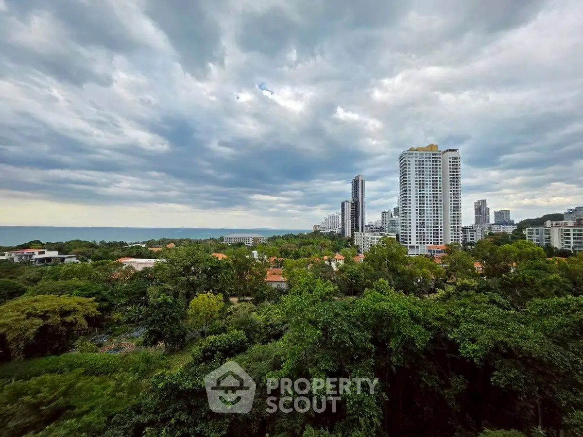 Stunning cityscape view with lush greenery and modern high-rise buildings under a dramatic sky.