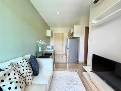 Modern living room with stylish decor and open kitchen layout in a cozy apartment.