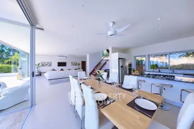 Spacious open-plan living and dining area with modern kitchen and garden view.