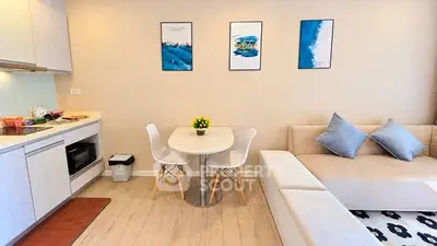 Modern living room with cozy sofa and stylish dining area in open layout apartment.