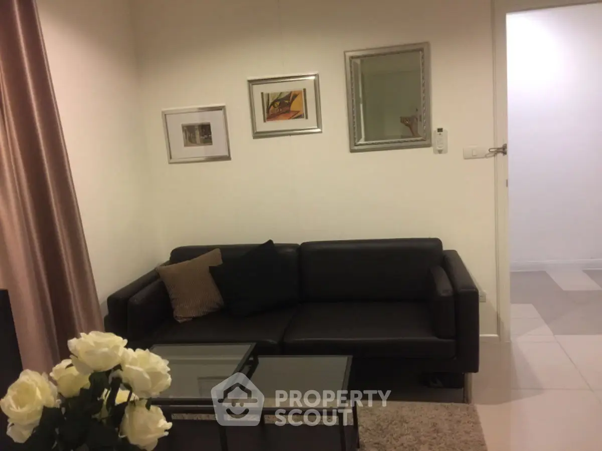 Cozy living room with modern black sofa and elegant decor