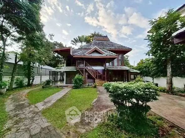 Charming two-story house with lush garden and unique architectural design