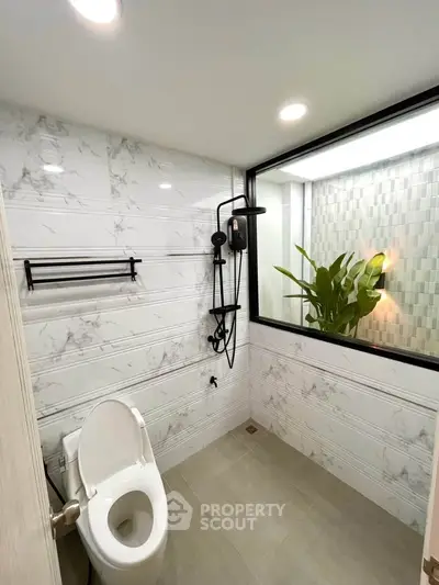 Modern bathroom with elegant marble tiles and stylish shower fixtures