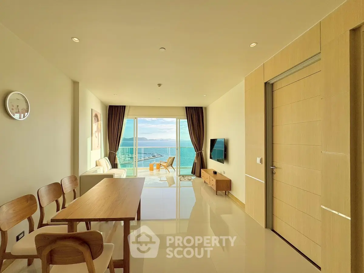 Stunning ocean view from modern living room with elegant decor and natural light.