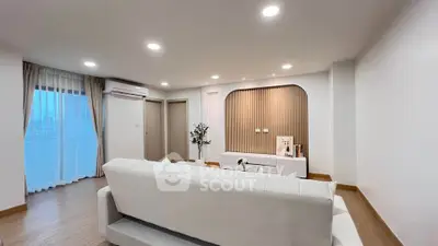 Spacious modern living room with elegant decor and large windows for natural light.