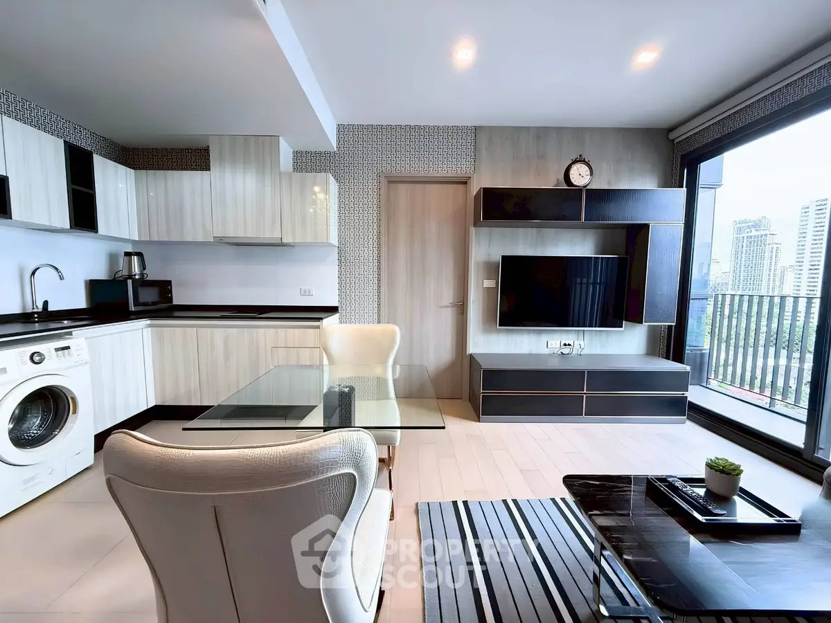 Modern open-layout living room with kitchen, featuring sleek furniture and city view balcony.