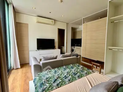 Modern studio apartment with open layout, featuring cozy living area and stylish kitchen.