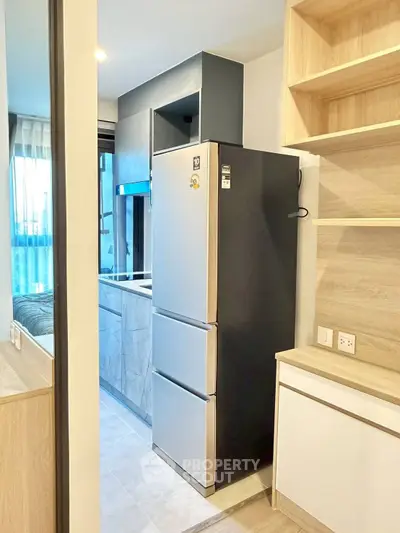 Modern kitchen with sleek fridge and ample storage space