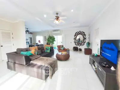 Spacious living room with modern decor and ample natural light