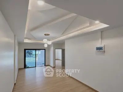 Spacious modern living room with elegant ceiling design and wooden flooring