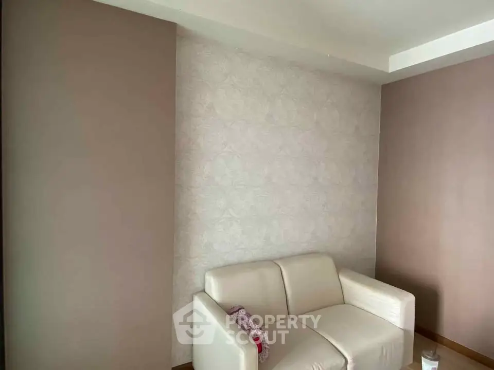 Cozy living room with elegant wallpaper and modern white sofa