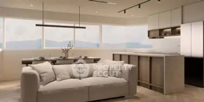 Modern open-plan living room and kitchen with mountain views, featuring sleek furniture and natural light.