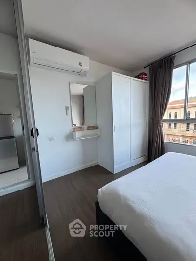 Modern bedroom with air conditioning and large window view
