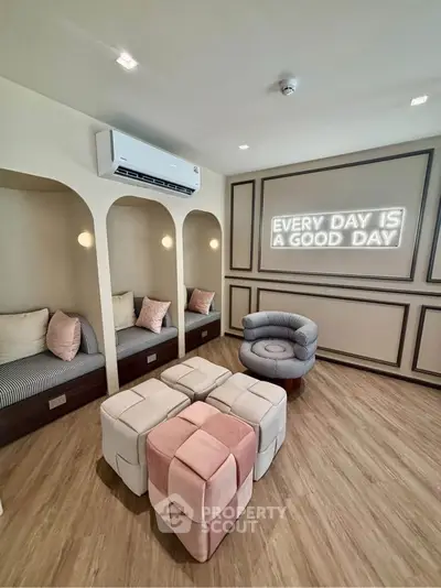 Stylish modern living room with cozy seating and motivational wall art, perfect for relaxation and inspiration.