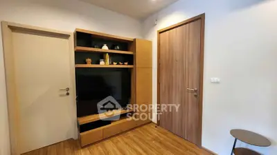 Modern living room with wooden flooring and built-in TV unit