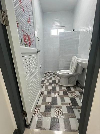 Compact bathroom with modern tiling and white fixtures