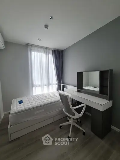 Modern minimalist bedroom with sleek furniture and natural light