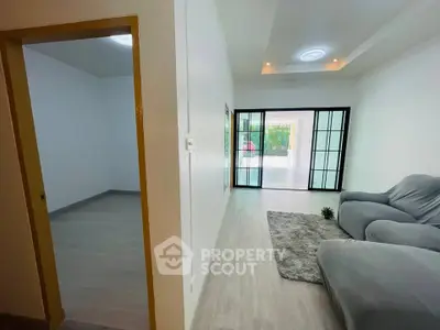 Spacious living room with sliding glass doors and cozy seating area.