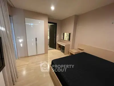 Modern bedroom with sleek design and ample storage in a stylish apartment.