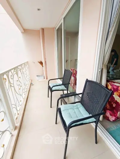 Charming balcony with elegant railing and cozy seating, perfect for relaxation.