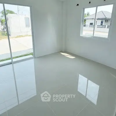 Bright and spacious empty room with large windows and glossy tiled floor