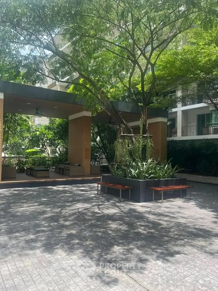 Lush garden area with seating in modern residential complex