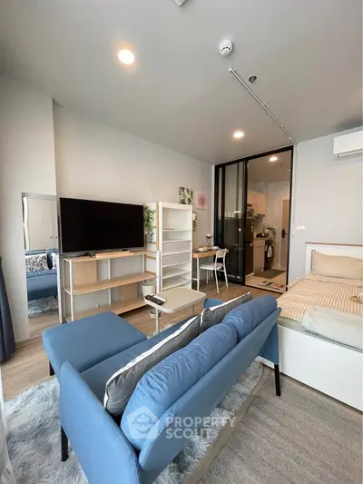 Modern studio apartment with cozy living area and stylish decor