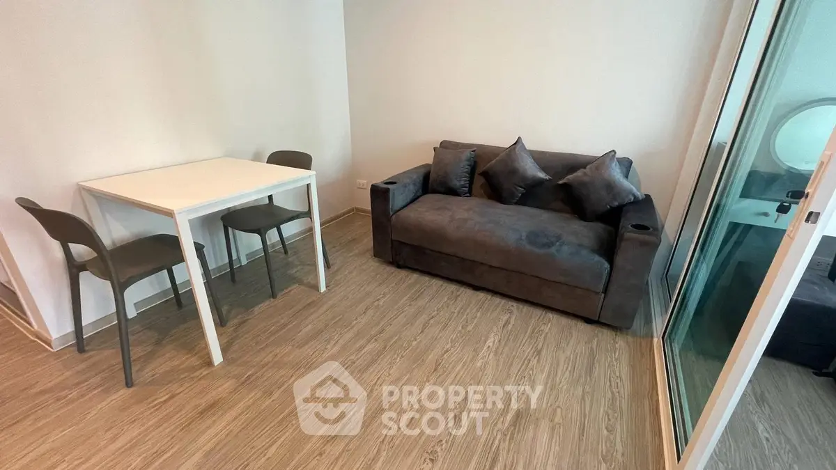 Modern living room with cozy sofa and dining table in a stylish apartment.