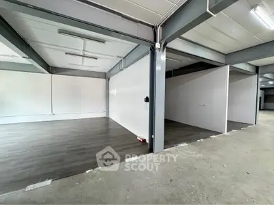 Spacious industrial-style interior with modern flooring and open layout, ideal for versatile use.