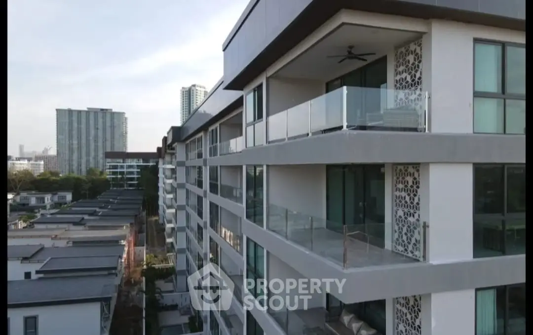 Modern apartment building with spacious balconies and city view.