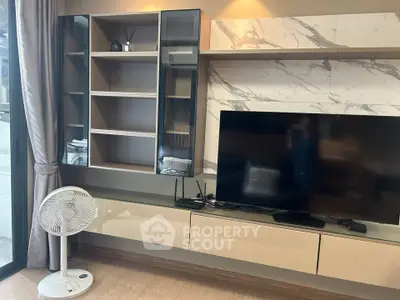 Modern living room with sleek TV unit and glass cabinets, featuring a stylish marble accent wall.