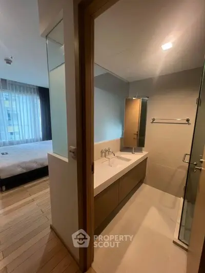 Modern bathroom with sleek design and adjacent bedroom view