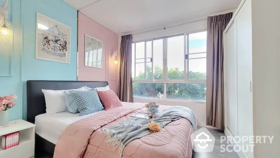 Charming bedroom with pastel decor and large window view