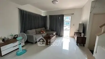 Spacious living room with modern decor and natural light