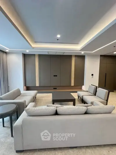 Modern living room with sleek furniture and recessed lighting