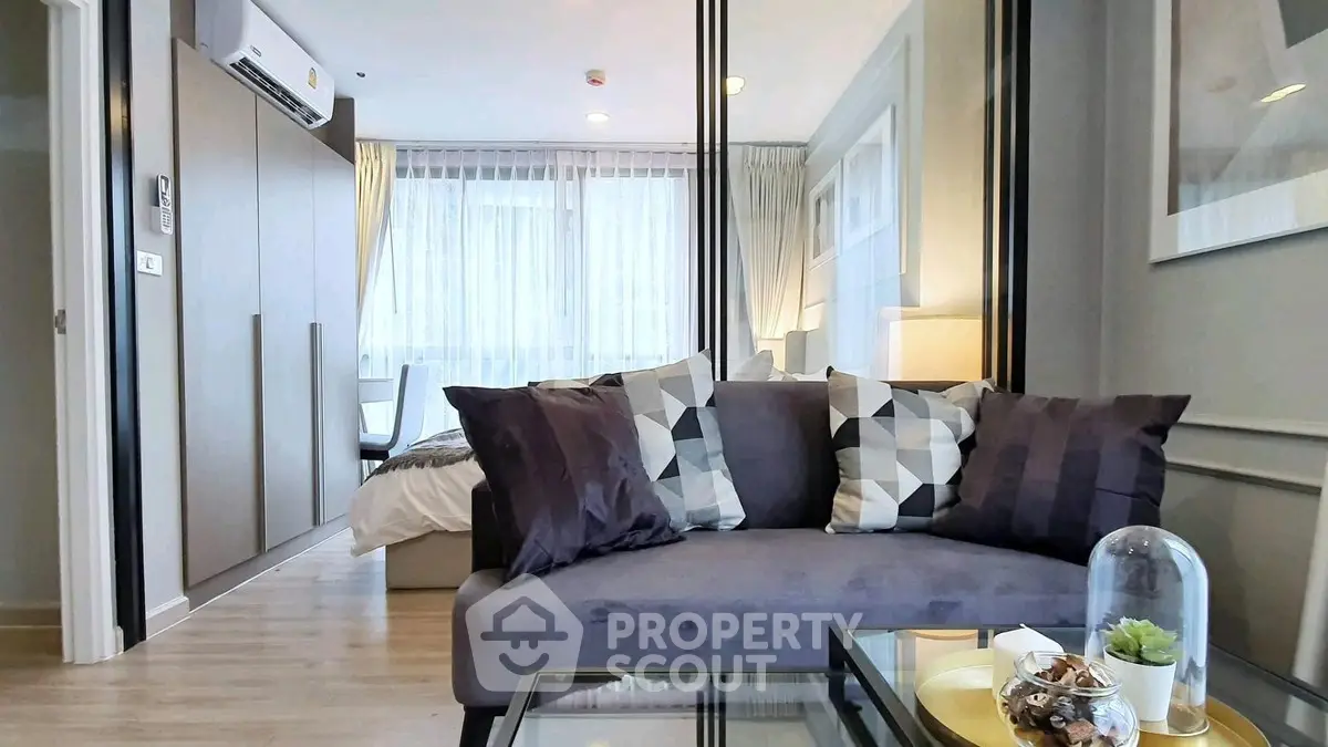 Modern living room with stylish decor and cozy ambiance in a contemporary apartment.