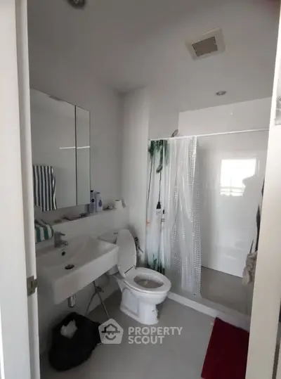 Modern bathroom with shower and sleek fixtures in a contemporary home.