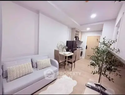 Modern living room with cozy sofa, dining area, and stylish decor in a compact apartment.