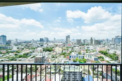 Stunning cityscape view from a high-rise balcony, showcasing urban skyline and vibrant city life.
