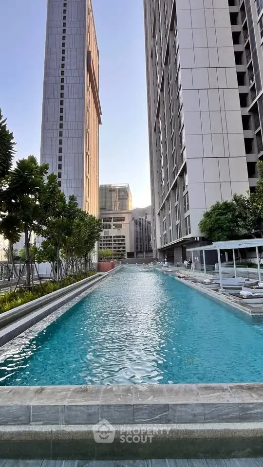 Luxurious high-rise residential complex with stunning outdoor pool and modern architecture.
